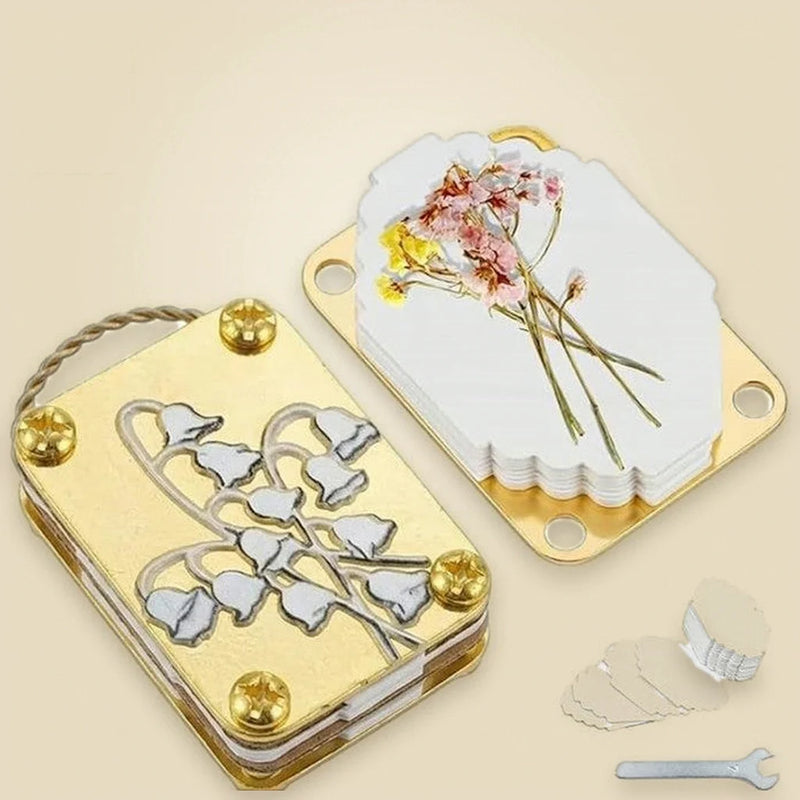 Opened flower press with absorbent paper and pressed flowers